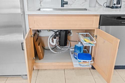 a kitchen cabinet with a sink and lots of tools at 20 percent OFF Fully Furnished 2BR in Prime Tustin in Tustin