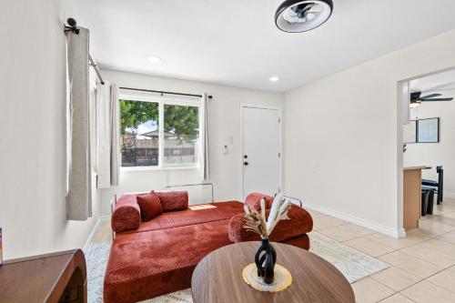a living room with a red couch and a table at 20 percent OFF Fully Furnished 2BR in Prime Tustin in Tustin