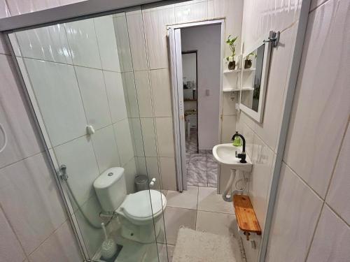 a bathroom with a toilet and a sink at Dunas Apart 2 Refúgio Completo a 1Km da Praia de Santo Antonio in Mata de Sao Joao