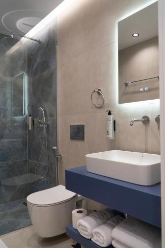 a bathroom with a sink and a toilet and a shower at Erdeti Boutique Hotel in Sarandë