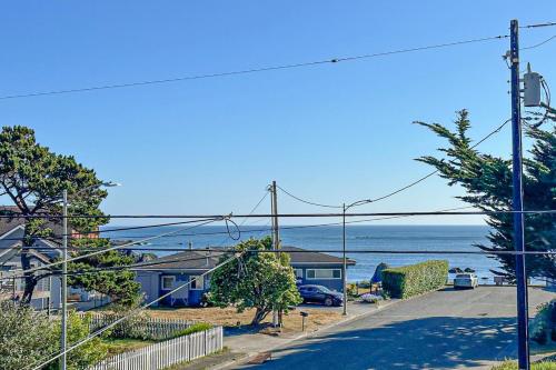 a street with houses and the ocean in the background at This Is It in Crescent City