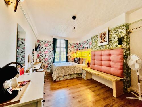 a bedroom with colorful walls and a bed in a room at Rest Boutique Portobello in London