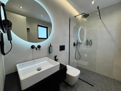 a bathroom with a white sink and a mirror at Erdeti Boutique Hotel in Sarandë