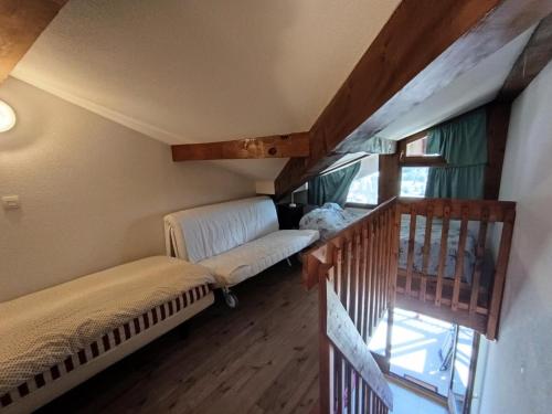 ein Wohnzimmer mit einer Couch und einer Treppe in der Unterkunft Résidence Plein Soleil - Petit duplex 4 pers plein sud sur les hauteurs du village MAE-2803 in Montgenèvre