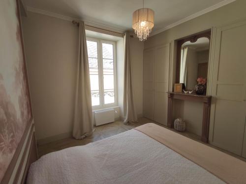 a bedroom with a bed and a large window at Ô Bulles de Loire, Châteauneuf-sur-Loire in Châteauneuf-sur-Loire