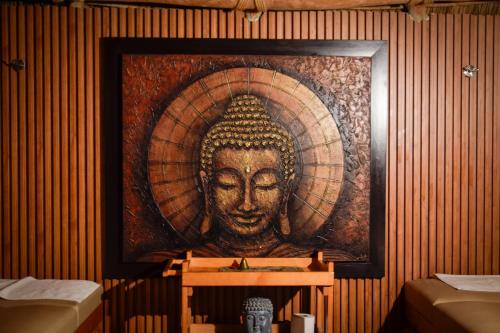 a large painting of a head on a wall at Casa Miura Hotel Boutique in Ajijic