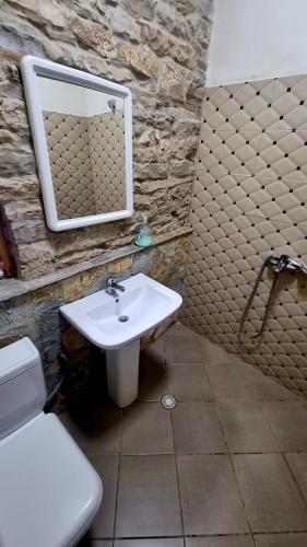 a bathroom with a sink and a mirror at Çelo's house Gjirokaster in Gjirokastër