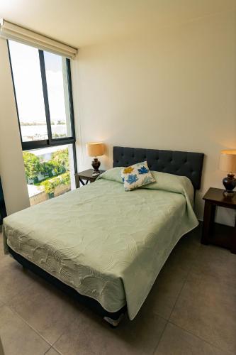 a bedroom with a bed with a pillow on it at Stay near Auditorio Telmex with A/C in Guadalajara