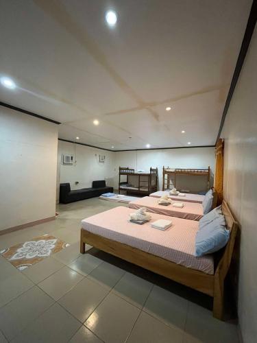 a bedroom with a large bed in a room at Harmony Place at Hillside in Puerto Princesa City
