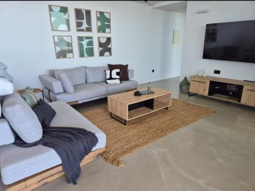 a living room with a couch and a coffee table at The Cliff in Melínta