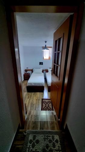 a view of a bedroom with a bed and a hallway at Çelo's house Gjirokaster in Gjirokastër