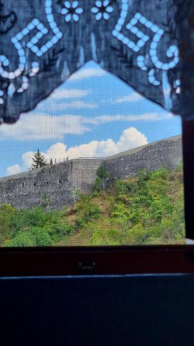 a view of a wall from a window at Çelo's house Gjirokaster in Gjirokastër