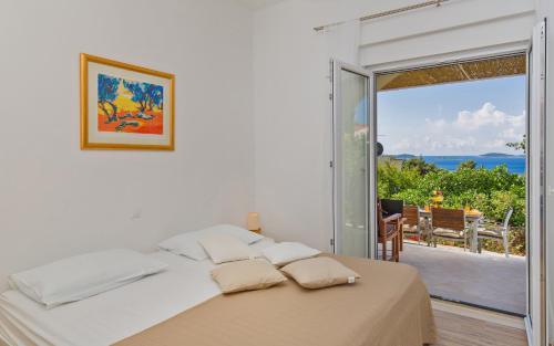 1 dormitorio con 1 cama y vistas al océano en Apartments Roza, en Mlini