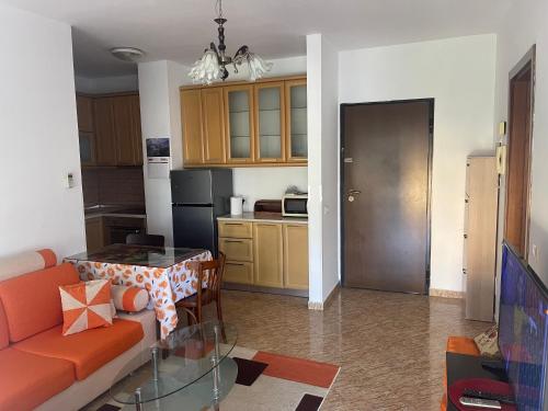a living room with a couch and a table at Sol Zoja Fusha e Aviacionit in Tirane