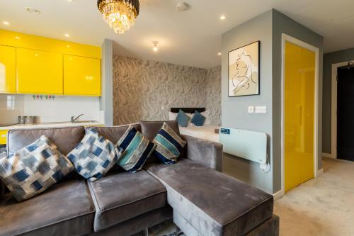 a living room with a brown leather couch at Cozy Studio Apartment in Sheffield in Sheffield