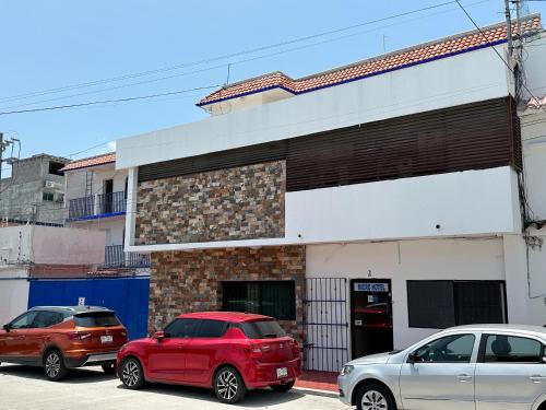 two cars parked in front of a building at Microhotel Ciudad del Carmen in Ciudad del Carmen