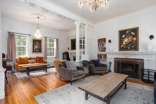 a living room filled with furniture and a fireplace at Berkshire Vacation Rentals 1900s Factory Turned Modern Berkshires Retreat in Great Barrington