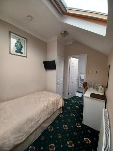 Ένα ή περισσότερα κρεβάτια σε δωμάτιο στο Hunters Lodge Guest House