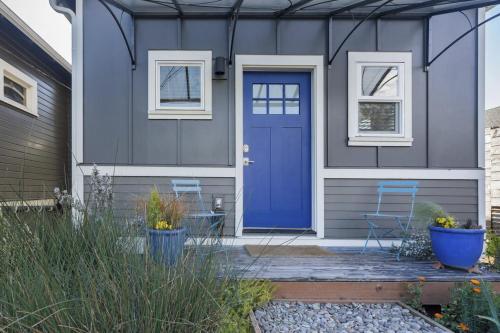 a blue door on a house with two chairs at Blue Door Micro-Loft in Portland
