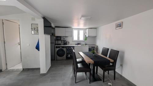 a kitchen with a table and chairs in a room at Casa do Páteo in Alcabideche