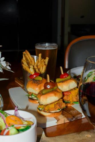 a table with sandwiches and french fries and a glass of beer at Francis Marion Hotel in Charleston