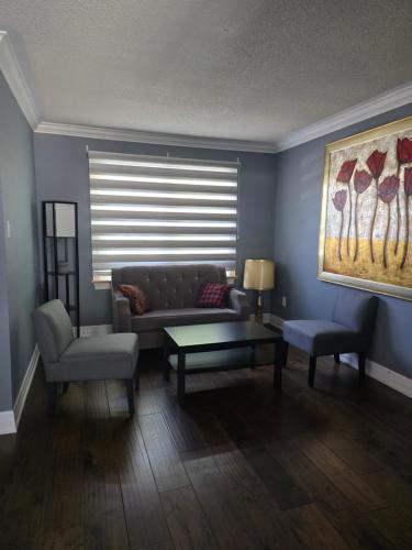 a living room with a couch and a table at Luxury home 4BR, Pool, & 5 Mins to 401 in Whitby