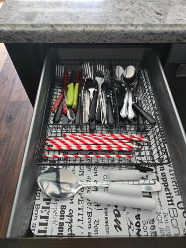 a drawer filled with utensils on a shelf at Luxury home 4BR, Pool, & 5 Mins to 401 in Whitby