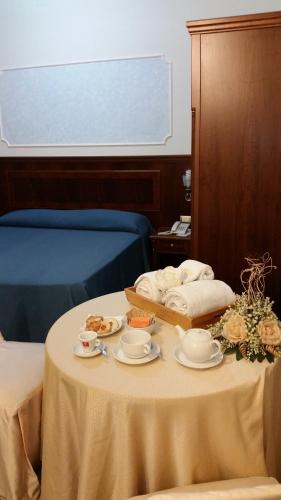 a table with plates and bowls of food on it at Grand Hotel Stella Maris Italia in Palmi