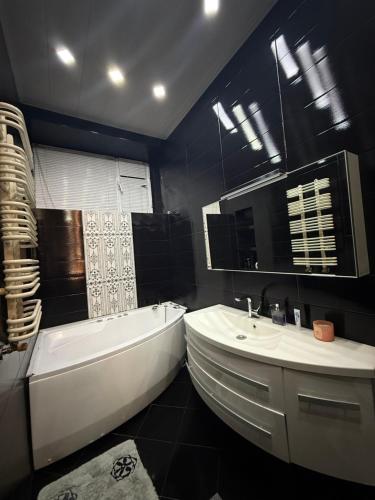 a bathroom with a tub and a toilet and a sink at Квартира в центре тбилиси in Tbilisi City