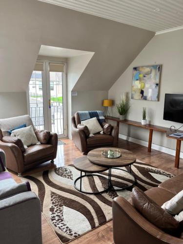 a living room with couches and a coffee table at Lahinch Central 3-Bed Retreat in Lahinch