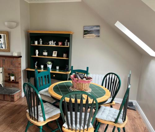 a dining room with a table and four chairs at Lahinch Central 3-Bed Retreat in Lahinch