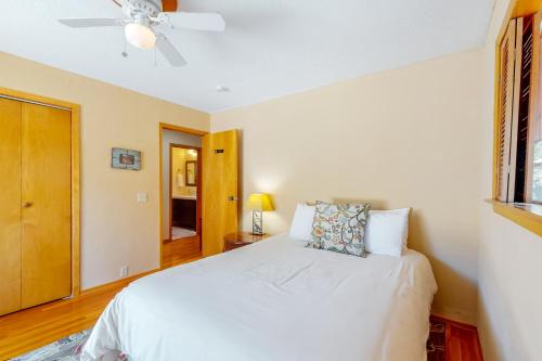 a bedroom with a white bed and a ceiling fan at Hawkins Bar River Home in Hawkins Bar