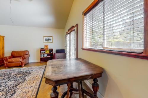 a room with a wooden table and a window at Hawkins Bar River Home in Hawkins Bar