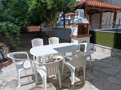 a white table and chairs and a grill at Olga Luxury Apartment in Paralia Katerinis