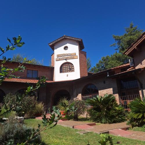 a building with a clock tower on top of it at Hotel Antiguo Camino in Villa General Belgrano