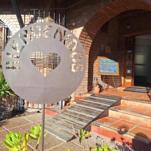 a heart sign in front of a building at Hotel Antiguo Camino in Villa General Belgrano