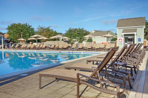 a group of chairs sitting next to a swimming pool at Club Wyndham Kingsgate in Williamsburg