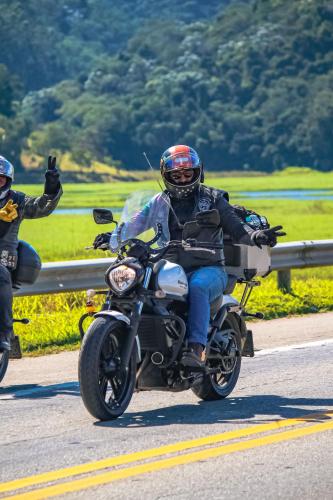 a man riding a motorcycle down a road at Apto02 in Sao Paulo