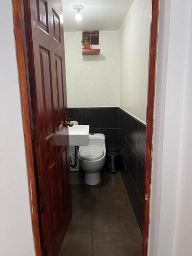 a bathroom with a white toilet and a sink at HOME BLESSED II in Lima