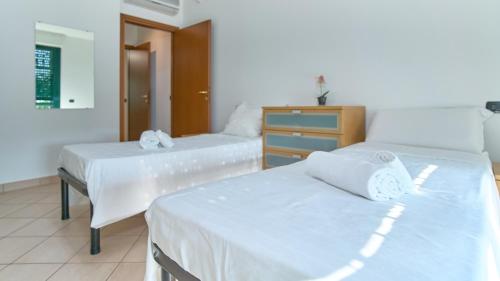 a room with two beds and a dresser in it at App 7 Modern apartment with private garden in Monza