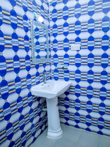a blue and white bathroom with a sink at Nungwi Modern Apartment 2 in Kinyasini
