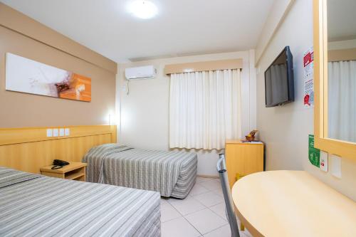 Ένα ή περισσότερα κρεβάτια σε δωμάτιο στο Hotel Express São Leopoldo