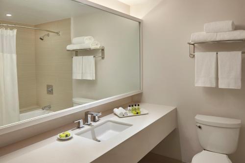 a white bathroom with a sink and a mirror at InterContinental Toronto Centre by IHG in Toronto
