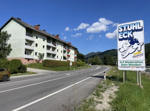 a sign on the side of a road next to a building at Spital Am Semmering Apartment - Stuhleck in Spital am Semmering