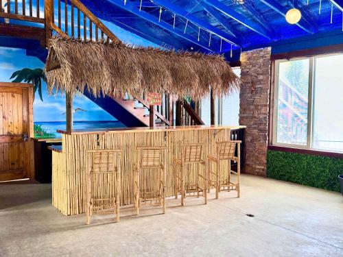 a bar with chairs and a table in a building at Barndominium at Paradise Pointe in Bryant