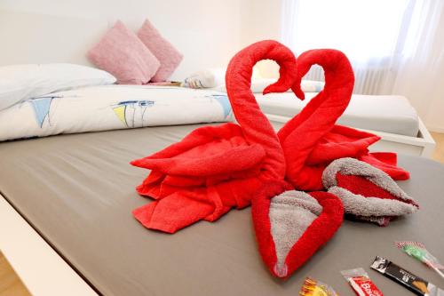 a bed with two red towels on it at Ferienwohnung Milan mit schönem Blick ins Grüne - Mein SWH in Todtmoos
