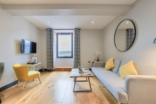a living room with a couch and a table at Oban Bay Apartments in Oban