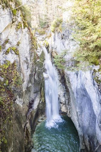 a waterfall in the middle of a rocky canyon at Feuriger Tatzlwurm Berghotel & Spa, BW Signature Collection in Oberaudorf