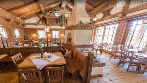 a dining room with tables and chairs in a building at Feuriger Tatzlwurm Berghotel & Spa, BW Signature Collection in Oberaudorf