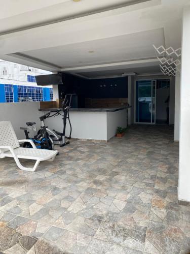 a patio with a chair and a table and a counter at Hotel residencial bella vista in Mocoa